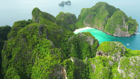 Green-cliffs-surrounding-Maya-Bay-are-seen-from-above-on-Phi-Phi-islands,-Thailand
