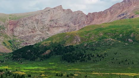 Drone-side-to-side-trucking-pan-establishes-epic-colorado-ridgeline-mountain-and-vibrant-green-guanella-pass