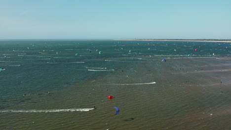 Tourists-Kitesurfing-In-The-Ocean-In-Brouwersdam,-Netherlands---aerial-panoramic