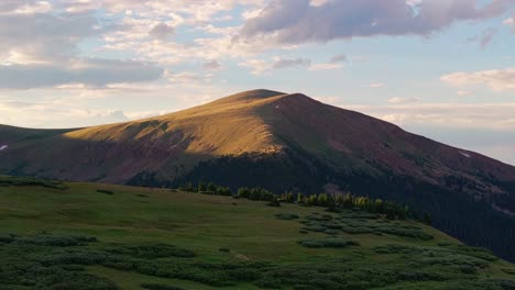 Harsh-golden-hour-light-cast-on-guanella-pass-mountain-peak,-alpenglow-on-stunning-colorado-mountains