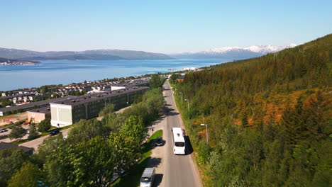 Bus-ride-along-lush-green-forest-and-urban-area-in-Tromso,-Norway