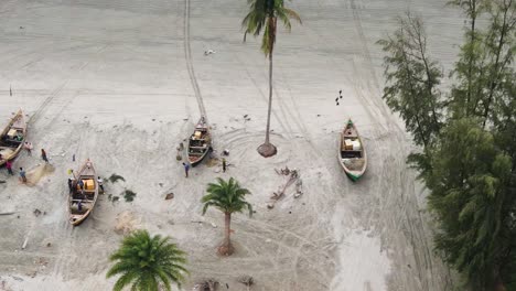 traditional-wooden-fishing-boat,-fishing-net-repair,-fishermen,-kuakata-sea-beach-shore,-bangladesh,-fishing-village