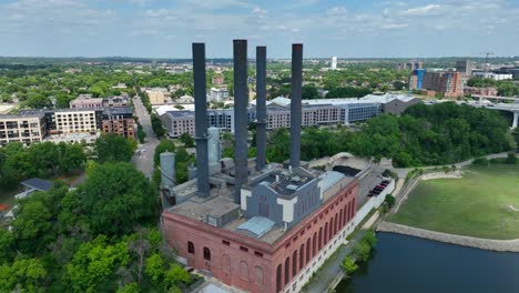 Old-factory-with-smokestacks-on-Mississippi-River-in-Minneapolis,-Minnesota