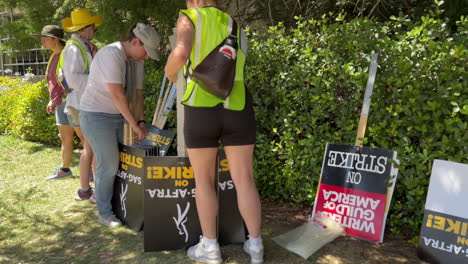 WGA-and-SAG-AFTRA-Strikers-Organizing-Picket-Sign-Distribution-at-Warner-Brothers-Studio,-Across-from-Gate-2-on-W-Olive-Ave