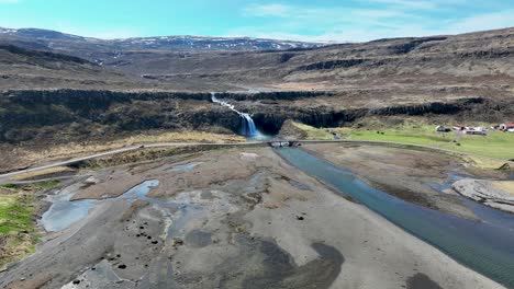 Scenic-Fossfjordur-Waterfall-On-The-Westfjords-Peninsula,-Iceland---aerial-drone-shot