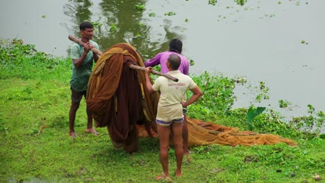 Landfischer-Heben-Fischnetz-Auf-Die-Schulter,-Nachdem-Sie-An-Einem-See-In-Bangladesch-Angeln