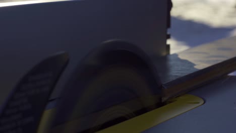 Carpenter-Cutting-Wood-On-A-Table-Saw,-Closeup-Of-Sharp-Blade