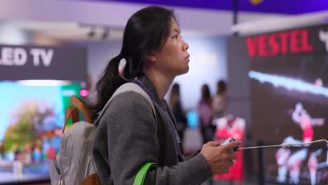 Woman-playing-the-Playstation-5-at-IFA-2023