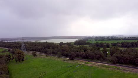 Aerial-Pan-Left-Clip-Showing-Powerlines-And-Alumina-Mine-On-Rainy-day