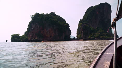 Passenger-view-of-rock-islands-in-sea-from-sailing-wooden-fishing-boat