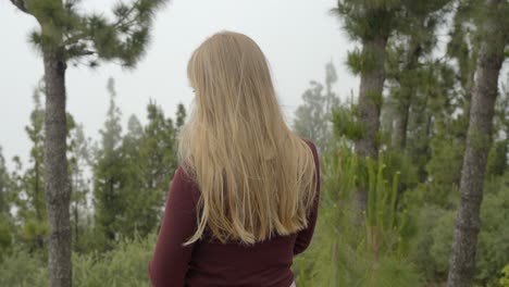 Blonde-woman-cant-see-landscape-because-of-thick-fog-from-mountain-top