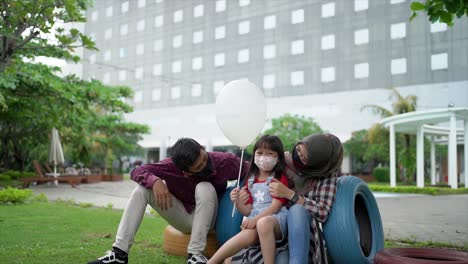 Fröhliche-Lächelnde-Tochter-Hält-Luftballons-Mit-Vater-Und-Mutter-Im-Sommerpark