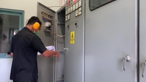 An-electrician-is-controlling-the-installation-in-the-generator-room