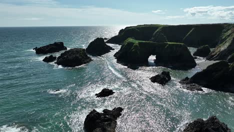 Coast-Ireland-establishing-shot-of-a-sea-arch-at-The-Copper-Coast-Ireland-on-an-evening-in-Summer