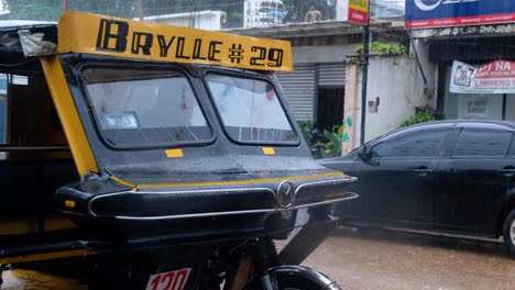 Close-up-of-Filipino-tricycle-taxi-during-wet-and-rainy-monsoon-in-Coron-Town,-Palawan-in-the-Philippines,-Southeast-Asia