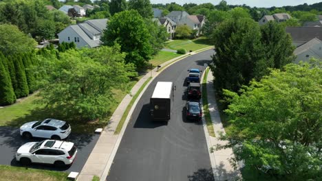 UPS-truck-driving-through-upscale-luxury-neighborhood-in-America