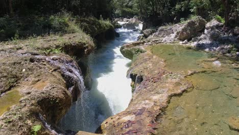 Whitewater-river-flows-underground,-below-limestone-at-Semuc-Champey