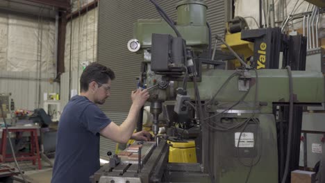 man-drill-on-metal-sheet-with-an-industrial-machine