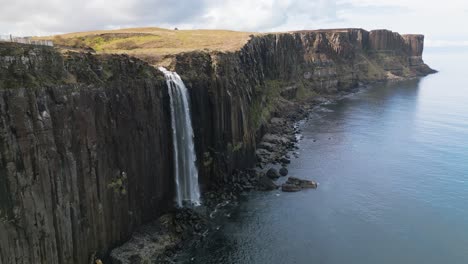 Drone-dolley-shot-of-the-large-mealt-falls-in-Scotland-while-a-bird-flies-by
