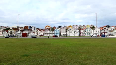 Colorful-neighborhood-with-palheiros-in-front-of-a-green-park-in-Costa-Nova,-Portugal