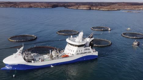 Drone-shot-circumnavigating-a-fishing-boat-on-a-Hebridean-fish-farm