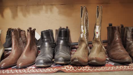Dolly-shot-of-old-cowboy-boots