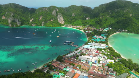 Idyllic-setting-of-Tonsai-village-in-Koh-Phi-Phi-with-ocean-either-side,-aerial