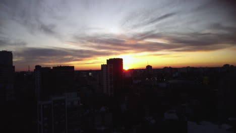 The-sun-sets-over-the-horizon,-the-sun-is-on-the-horizon,-sunrise-or-sunset-over-the-city,-shooting-from-a-drone