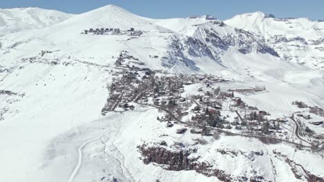 Panoramic-aerial-view-circling-Farellones-snowy-mountain-winter-landscape-and-scenic-village-on-the-Andes-mountains