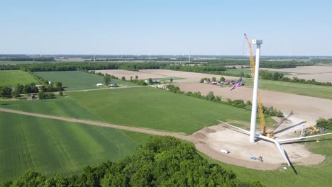Construction-site-with-spare-parts-of-wind-turbine,-aerial-drone-view