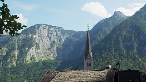 Evangelical-Church-tower-in-picturesque-town-of-Hallstatt-in-Austria,-cinematic