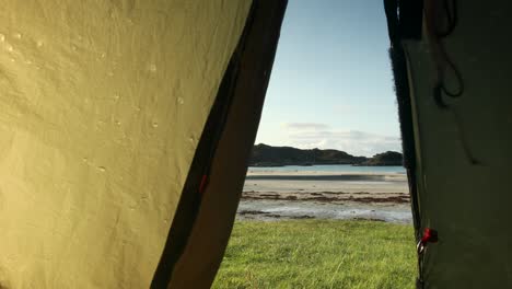 Tent-flapping-in-breeze-on-beach-on-Isle-of-Mull,-Scotland