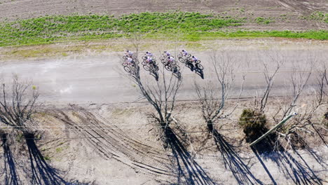 Drone-Shot-of-Road-Cyclists-on-Long-Open-Road