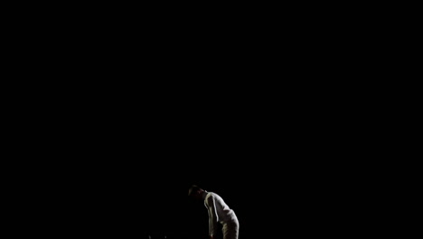 Beautiful-Male-gymnast-in-white-doing-acrobatic-stunts-on-black-background-in-slow-motion,-rotation-and-flips