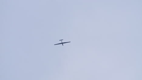 Tow-plane-helping-aerobatic-Glider-to-take-off,-low-angle,-tracking-shot,-day