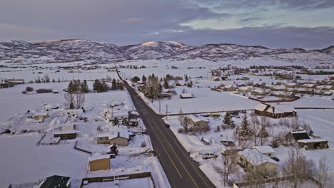 Oakley-Utah-Aerial-v5-cinematic-drone-flyover-town-area-along-the-road-capturing-pristine-snow-landscape-of-winter-wonderland-and-beautiful-mountainscape-views---Shot-with-Mavic-3-Cine---February-2023