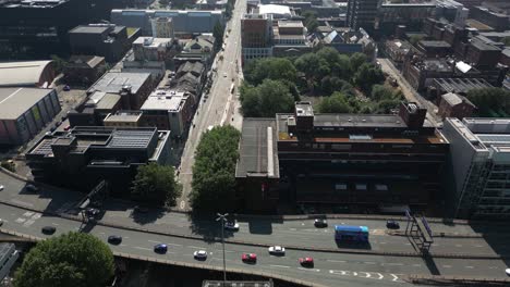 Aerial-drone-flight-along-Oxford-Road-heading-over-the-Mancunian-Way-and-All-Saints-Park-in-Manchester-city