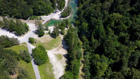 A-man-made-dam-creates-a-pristine-swimming-spot-in-the-lush-greenery-of-Idrijska-Bela,-offering-an-idyllic-nature-escape-for-summer-fun