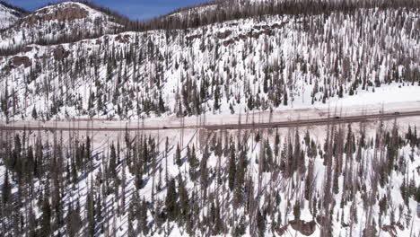 Aerial-View,-Traffic-on-Mountain-Pass-in-Rural-Colorado-USA-on-Sunny-Winter-Day,-Drone-Shot