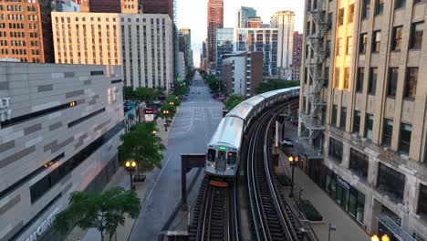 Chicago-public-train-on-elevated-train-tracks-headed-towards-drone