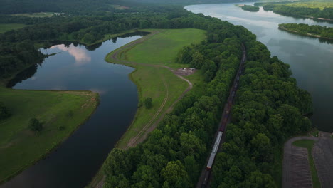 Train-passes-through-Spadra-Park,-near-Clarksville-and-Arkansas-River---Day-aerial-wide-shot