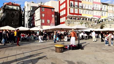 Lots-of-people-at-Cais-da-Ribeira-dancing-to-the-tunes-of-a-shirtless-street-guitar-player