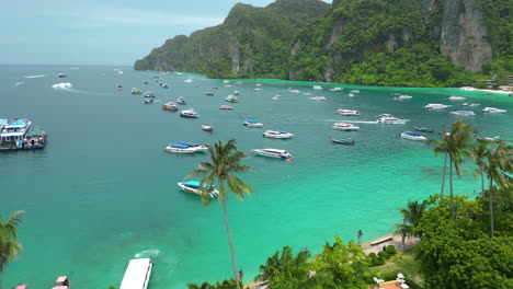 Aerial-of-tropical-thai-beach-with-boat-moored-at-bay-in-Thailand-Koh-Phi-Phi-islands-in-Krabi-province