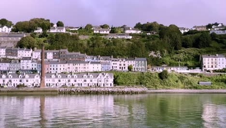 Passing-Cobh's-colourful-houses-and-old-industrial-chimney,-county-Cork,-Ireland