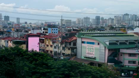 Aerial-skyline-view-of-capital-city-of-Manila-densely-packed-with-houses,-offices,-businesses-and-skyscrapers-in-Philippines,-Southeast-Asia