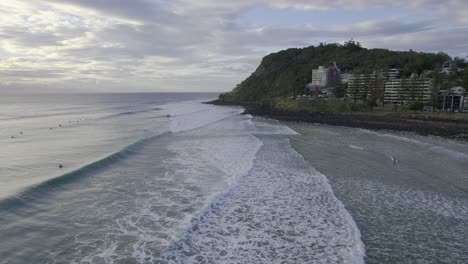 Burleigh-Beach-With-Surfers-On-A-Cloudy-Day-In-Queensland,-Australia---aerial-shot