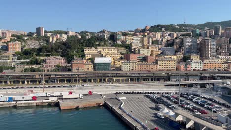 Panning-shot-of-the-scenic-stacked-houses,-the-cruise-port-and-the-skyline-cityscape-view-of-Genoa,-Italy