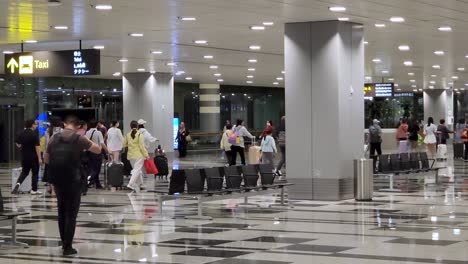 Gruppe-Von-Touristen,-Die-Im-Terminal-3-Des-Changi-Flughafens-In-Singapur-Spazieren-Gehen