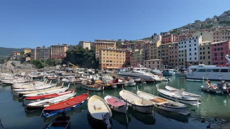 Point-of-view-of-picturesque-colourful-houses-and-boats-mooring-in-the-port-of-Liguria,-Camogli,-Italy