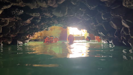 Family-swimming-in-Roman-Baths-of-Casares-Manilva,-natural-spring-healing-sulfur-water-in-Spain,-good-health-benefits,-4K-shot